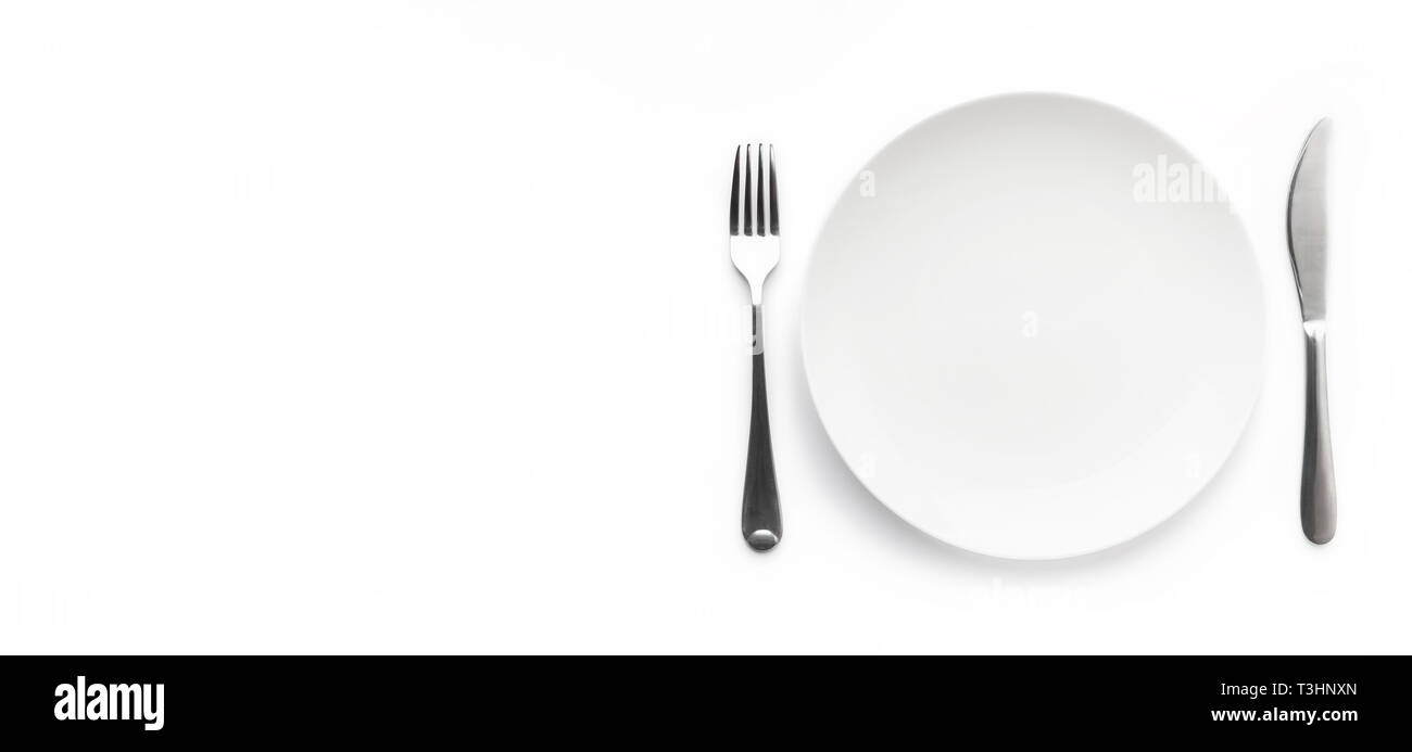Empty plate with fork and knife Stock Photo