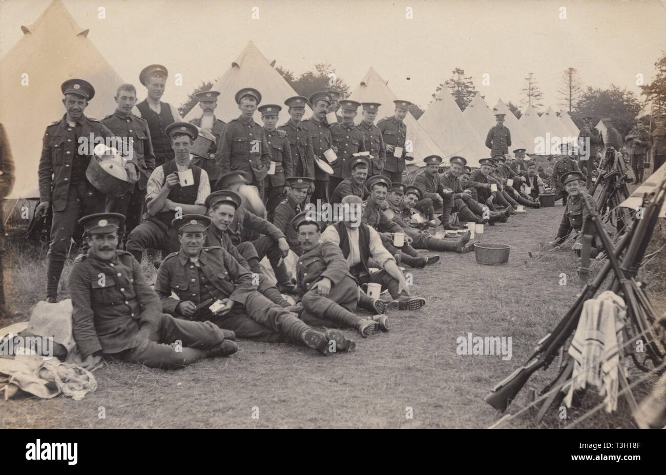 Vintage Photographic Postcard Showing British Army Soldiers Relaxing in Camp. Possibly at Bordon in Hampshire. Stock Photo