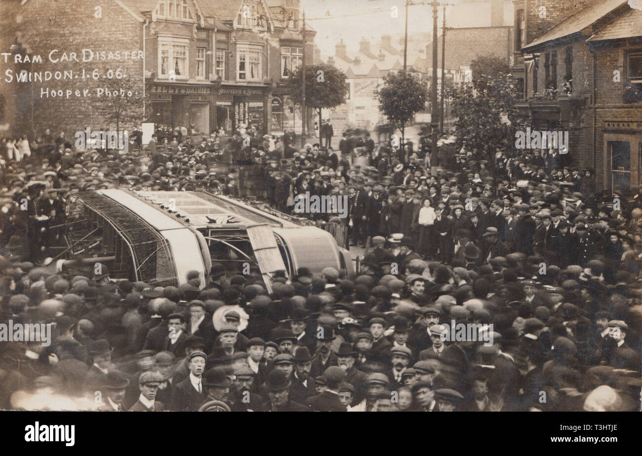 Vintage 1906 Photographic Postcard Showing The Tram Car Disasterr in Swindon, Wiltshire, England. Crowds of People Next To The Upturned Tram. Stock Photo