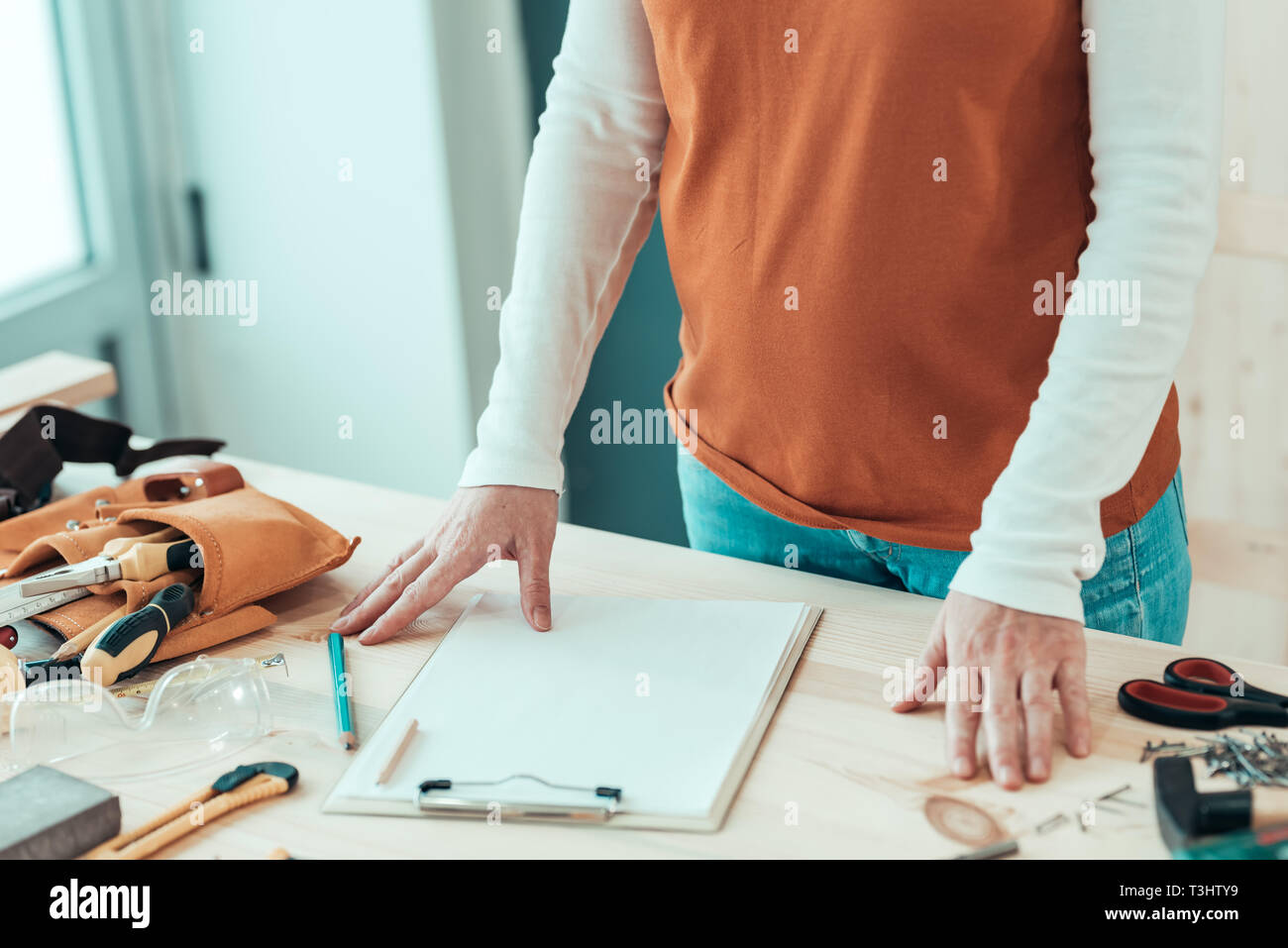 Female carpenter with hands on the desk in small business woodwork workshop Stock Photo