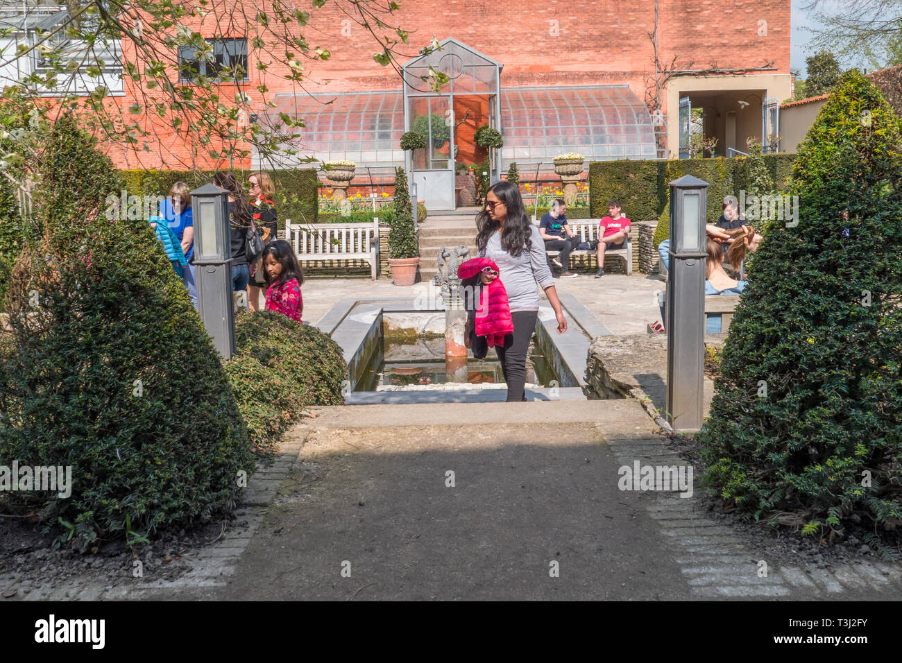 People Enjoying A Sunny Day In The Sunken Garden Of The Herbal Garden