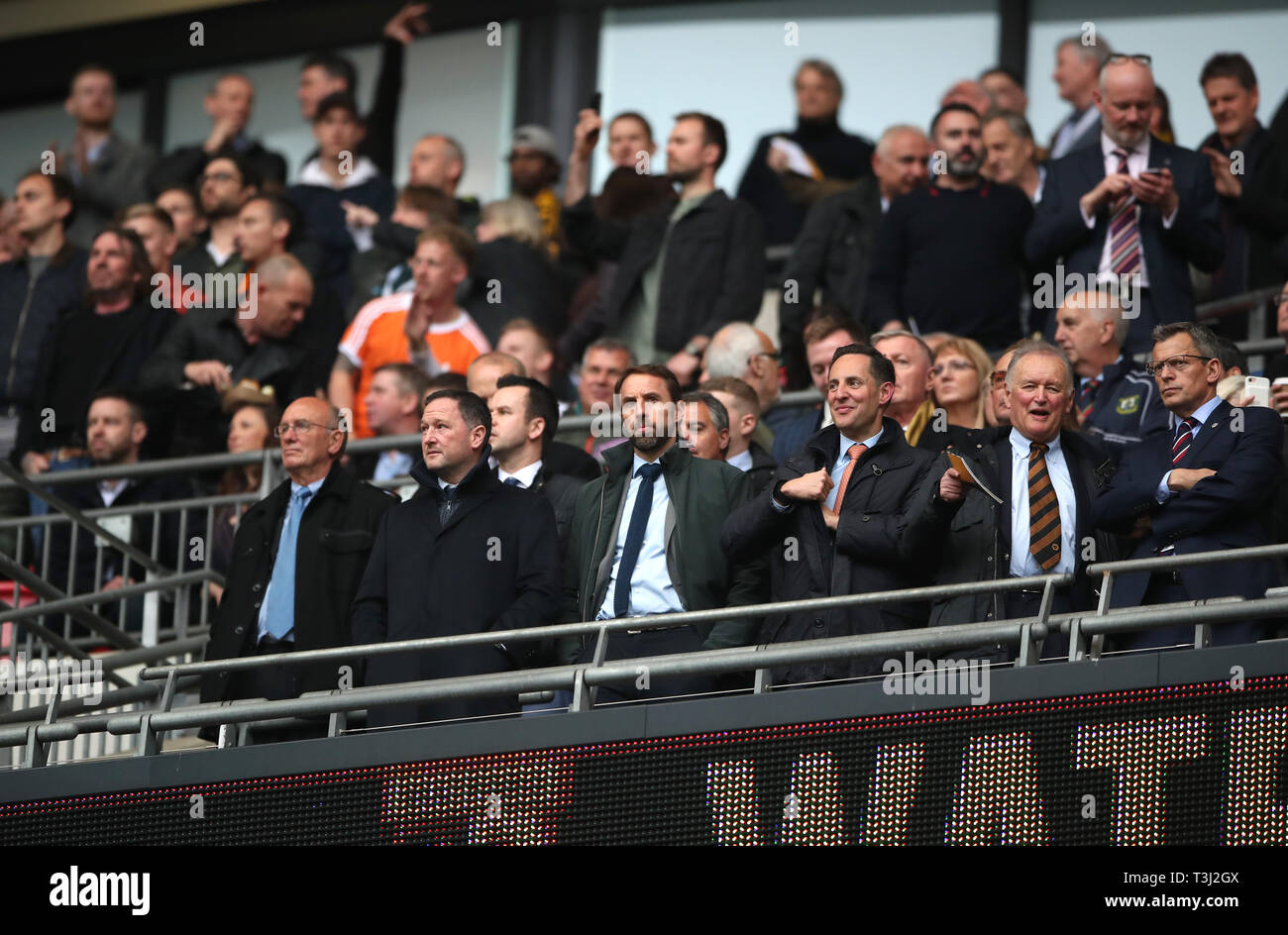 England manager Gareth Southgate (centre), assistant Steve Holland (second left) and departing FA Chief Executive Officer Martin Glenn (far right) in the stands during the FA Cup semi final match at Wembley Stadium, London. Stock Photo