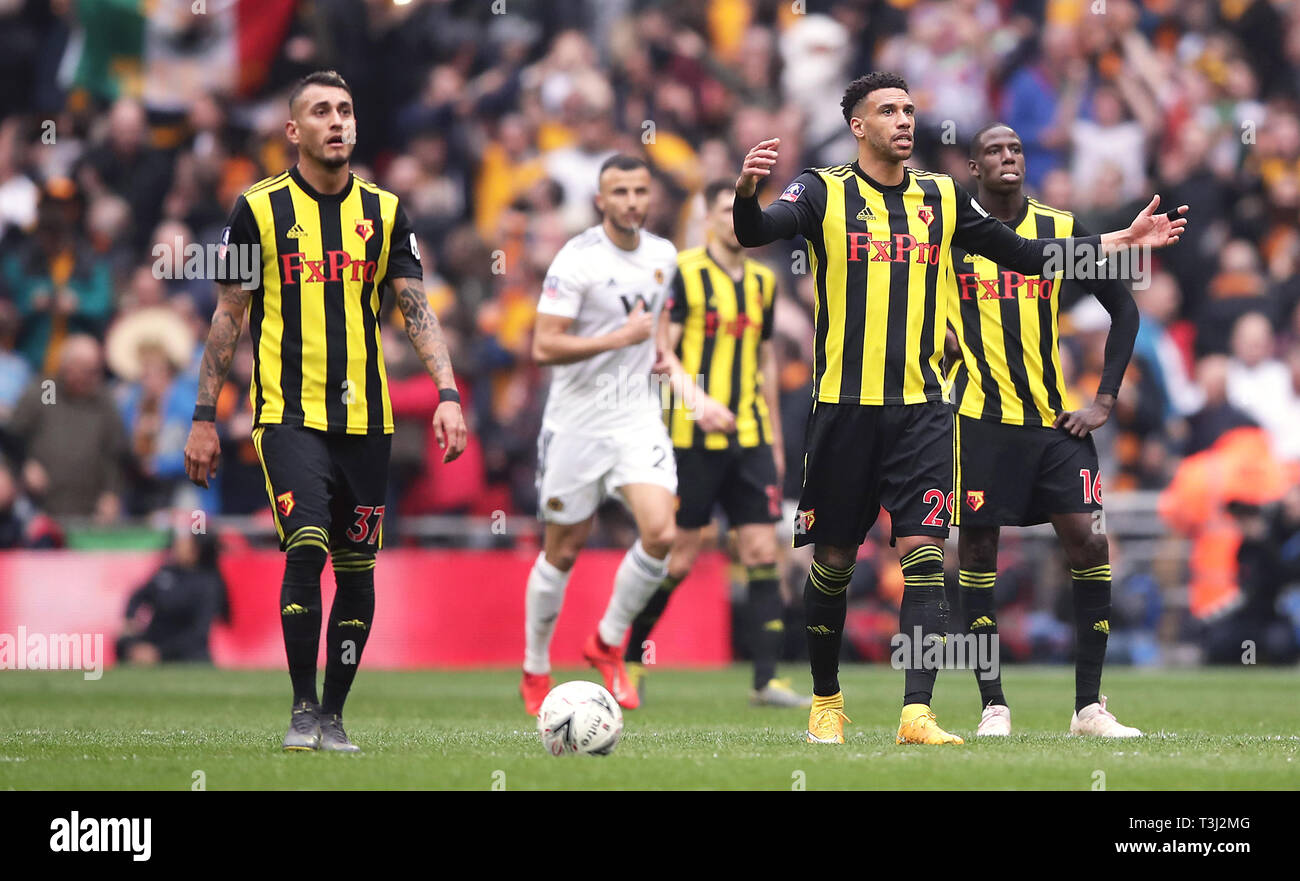 Watford's Roberto Pereyra (left), Etienne Capoue and Abdoulaye Doucoure (right) appear dejected after Wolverhampton Wanderers' Raul Jimenez (not pictured) scores his side's second goal of the game during the FA Cup semi final match at Wembley Stadium, London. Stock Photo