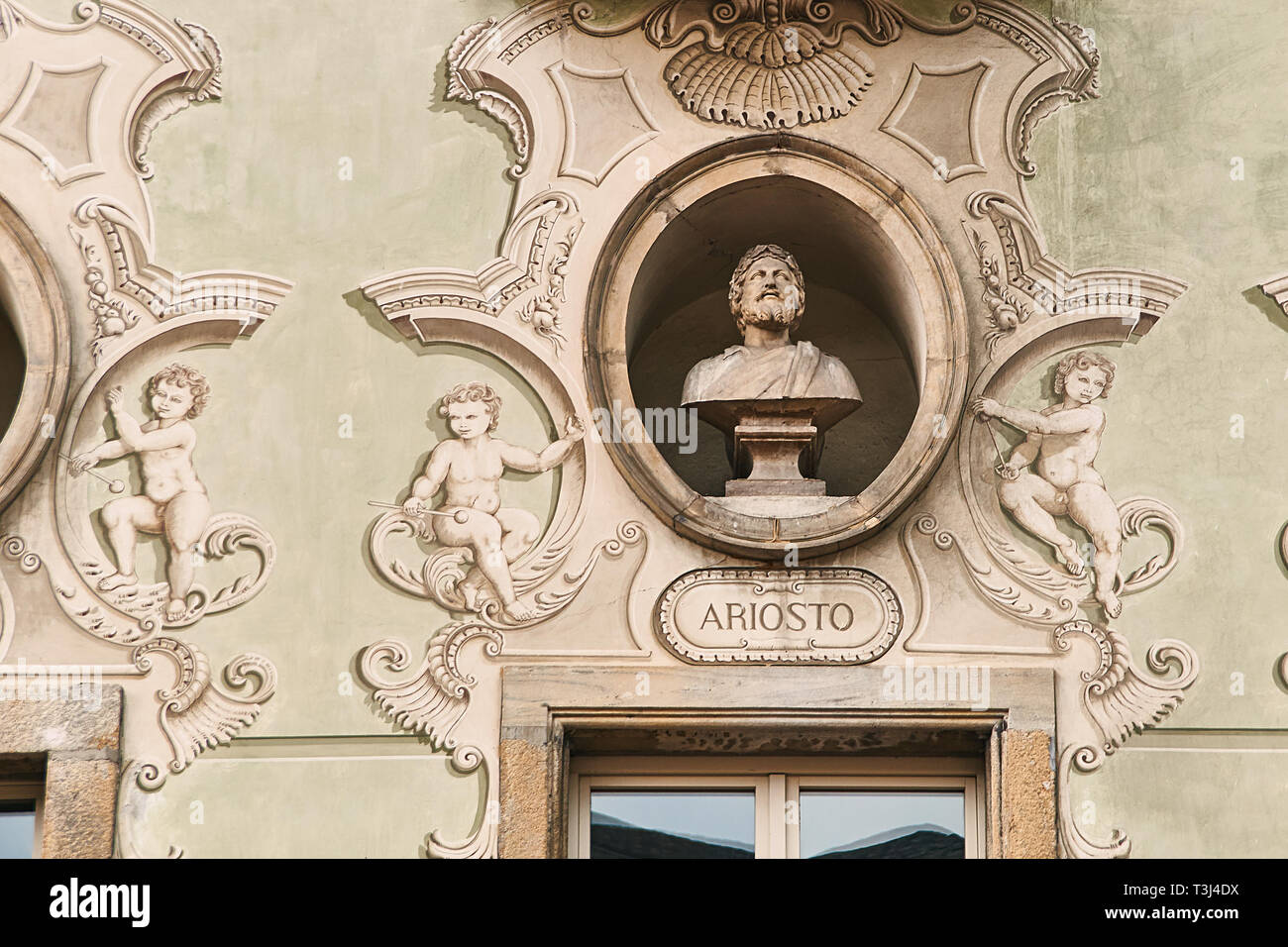 Vintage sculpture portrait of Ludovico Ariosto, a famous Italian poet best known as the author of the romance epic Orlando Furioso 1516 on a facade of Stock Photo