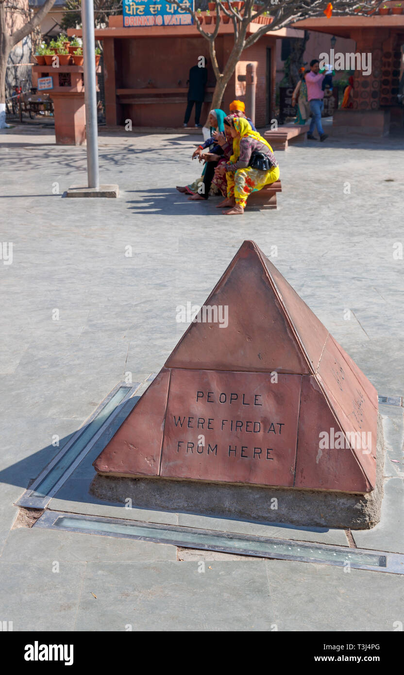 Marker where shots were fired, Jallianwala Bagh, a public garden in Amritsar, Punjab, India, commemorating the British Jallianwala Bagh Massacre and shooting Stock Photo