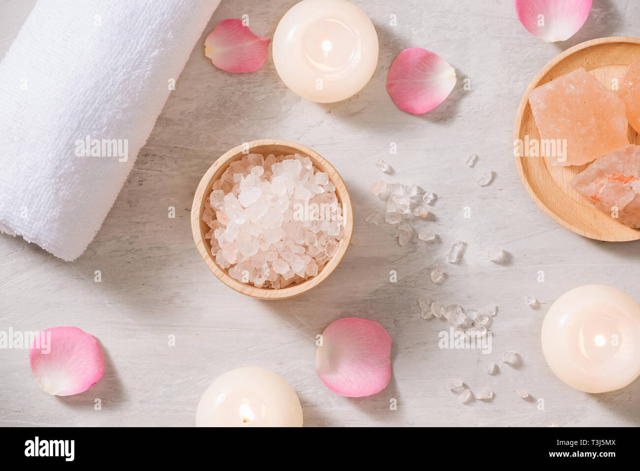 Spa settings with roses. Spa theme with candles and flowers on table. Stock Photo