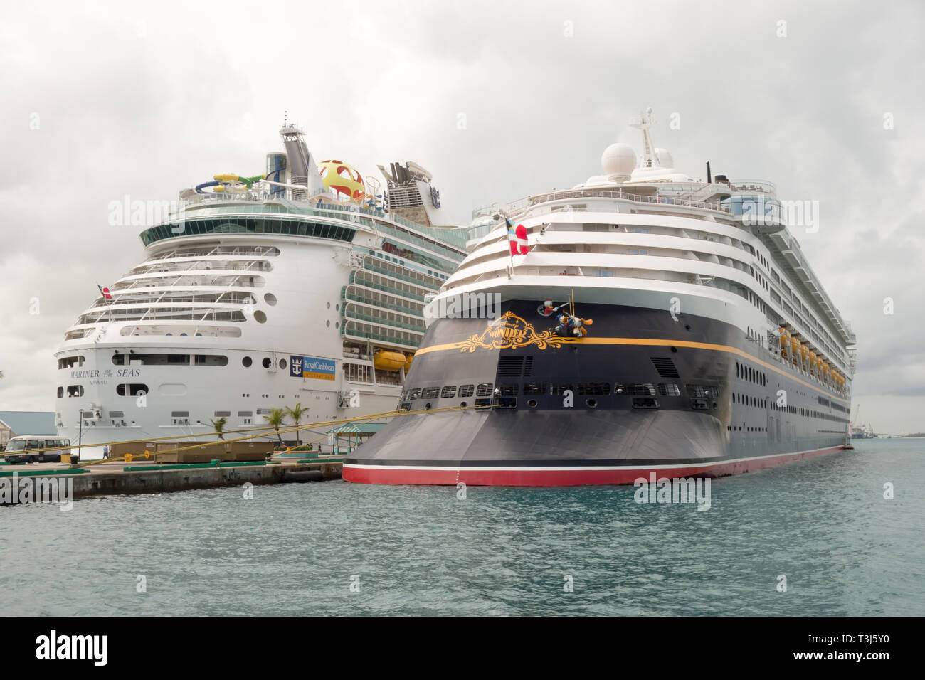 Disney Cruise Wonder is being docked next to Royal Caribbean International's Mariner of the Seas at Nassau's cruise port. Stock Photo