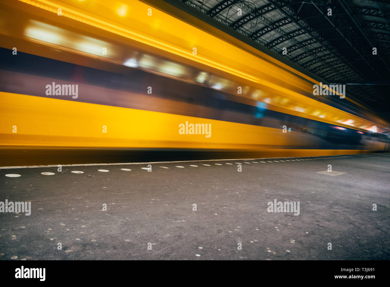 Blurred train motion with high speed at railway station Stock Photo