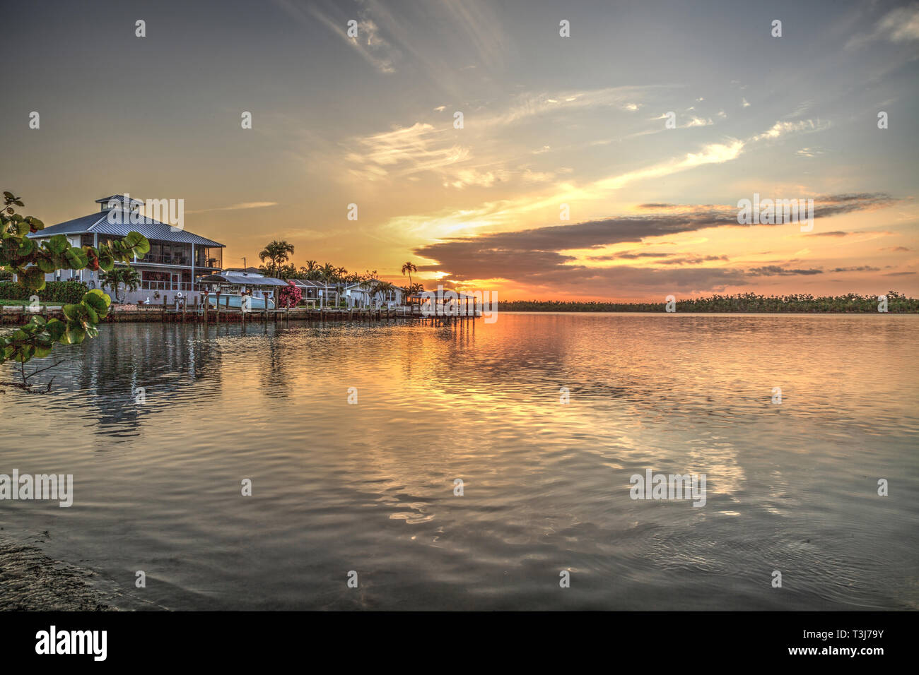 Waterway that leads to the ocean on Isle of Capri near Marco Island, Florida at Sunset Stock