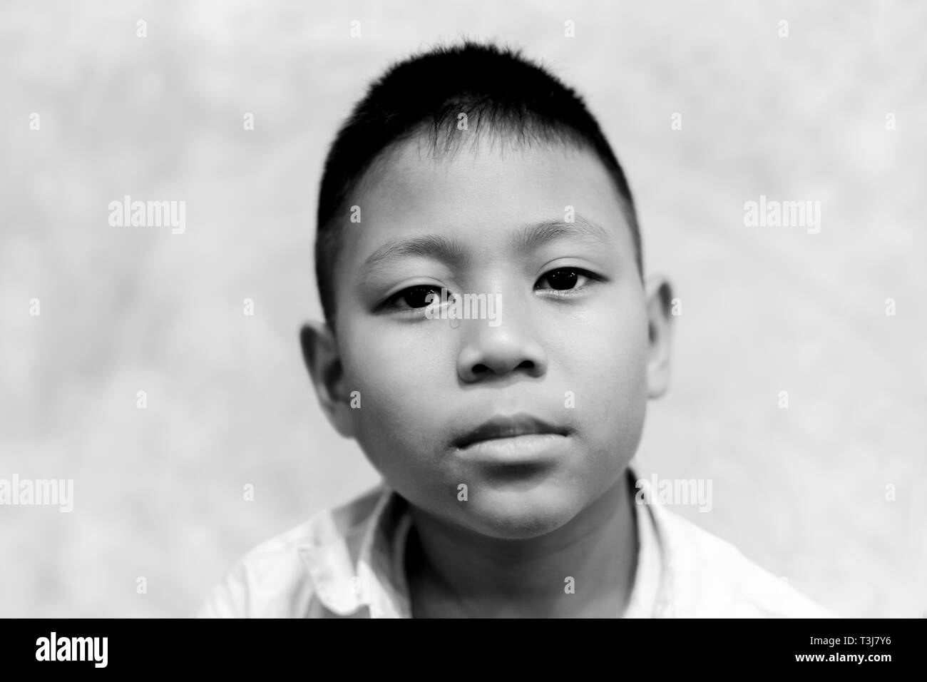 Portrait of asian boy crying with tear on his face in black and white. Stock Photo