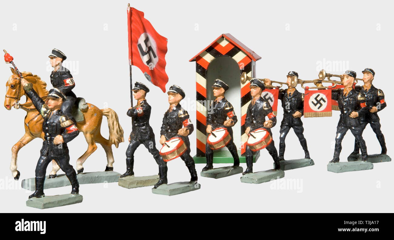 19 SS-toy figures, by the Lineol or Elastolin Companies A drum major, three drummers, three trumpeters, two marching men with service caps and overcoats, one standard bearer, one rider on horseback. Also Adolf Hitler with a moveable arm at a lectern, and a messenger dog, all from Lineol. Eight marching men (two damaged) with service caps by Elastolin. All from the 7 cm series. In addition a sentry's booth and six damaged Wehrmacht and foreign figures. historic, historical, people, 1930s, 1930s, 20th century, toy, toys, object, objects, stills, clipping, clippings, cut out, , Editorial-Use-Only Stock Photo