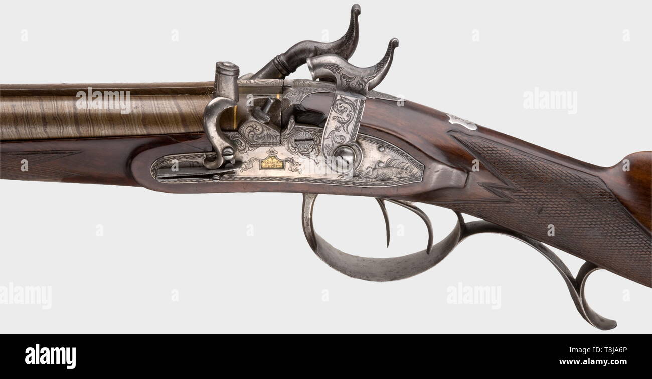 A double-barrelled percussion rifle, Störmer in Herzberg, circa 1810. Browned, side-by-side Damascus barrels with a patent breech-plug and eight-groove rifled bores in 16.5 mm calibre. Silver front sight and dovetailed iron rear sight. Converted percussion locks engraved with floral and hunting designs. Folding nipple protector. Each lock plate displays the gold-filled marks, 'STÖRMER HERZBERG' . Beautiful walnut half stock with a patchbox and chequered small of the stock. Iron furniture cut with arabesques and hunting designs. Silver escutcheon , Additional-Rights-Clearance-Info-Not-Available Stock Photo