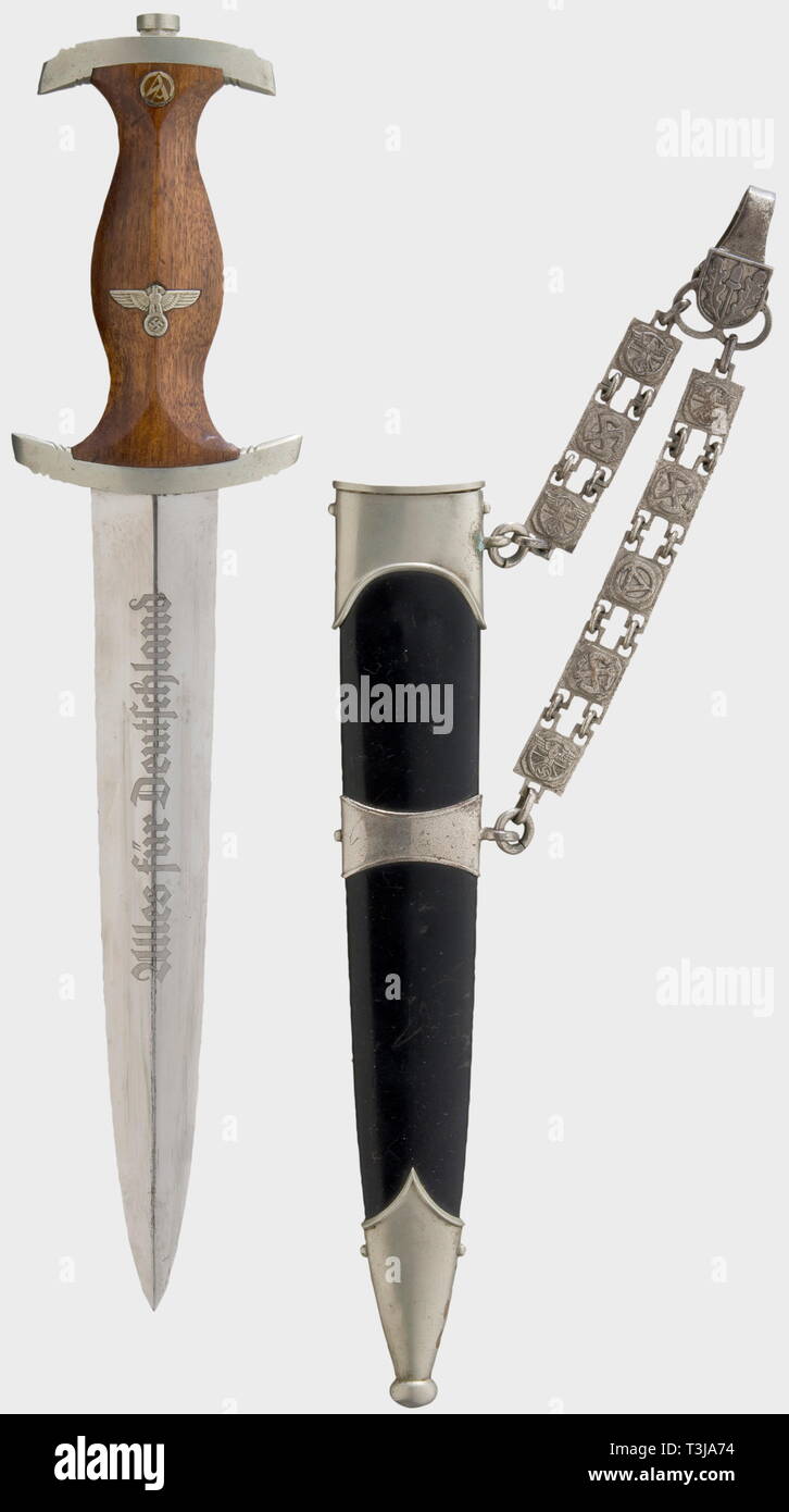 An NSKK model 1936 service dagger, with chain suspension Blade (nearly mirror-like) etched with the motto 'Alles für Deutschland' and with the maker's inscription, 'C.G. Haenel Suhl - Waffen - und Fahrradfabrik (C.G. Haenel Suhl - Weapons and Bicycle Factory) on the reverse side. Nickel-silver quillons (marked 'Sa' for Saxony). Brown wooden grip with both emblems. Contemporary re-lacquered scabbard with nickel-silver mountings and nickel-plated chain suspension (iron, worn on the back, stamped 'Musterschutz NSKK-Korpsführung' (Registered Design - NSKK-Leadership')). Length , Editorial-Use-Only Stock Photo