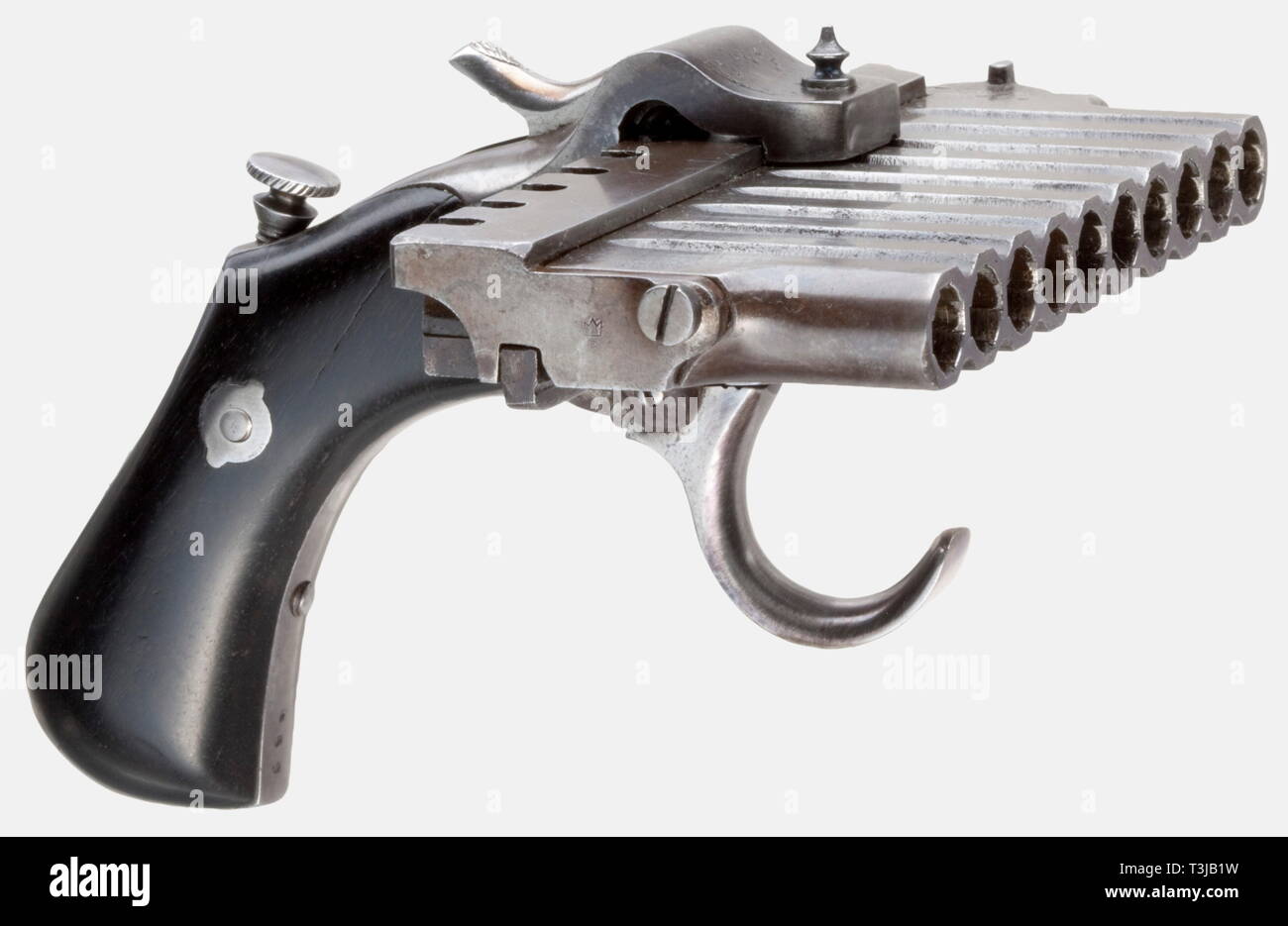 A rare Jarre pistol, France, circa 1880. In 7 mm Lefaucheux calibre. No. 469. Matching numbers. Ten-shot, pivoting rotatable barrel group. Receiver with double-action trigger. Smooth, blackened grip panels. A cartridge case ejector screwed into the grip frame. Metal parts with remnants of bluing. Length in carrying configuration 20 cm. When ready to fire 12.5 cm. Rare harmonica pistol according to the patent for A. Etienne and P.J. Jarre. The barrel group, operated by the double action trigger, moves from left to right as it is fired, allowing te, Additional-Rights-Clearance-Info-Not-Available Stock Photo