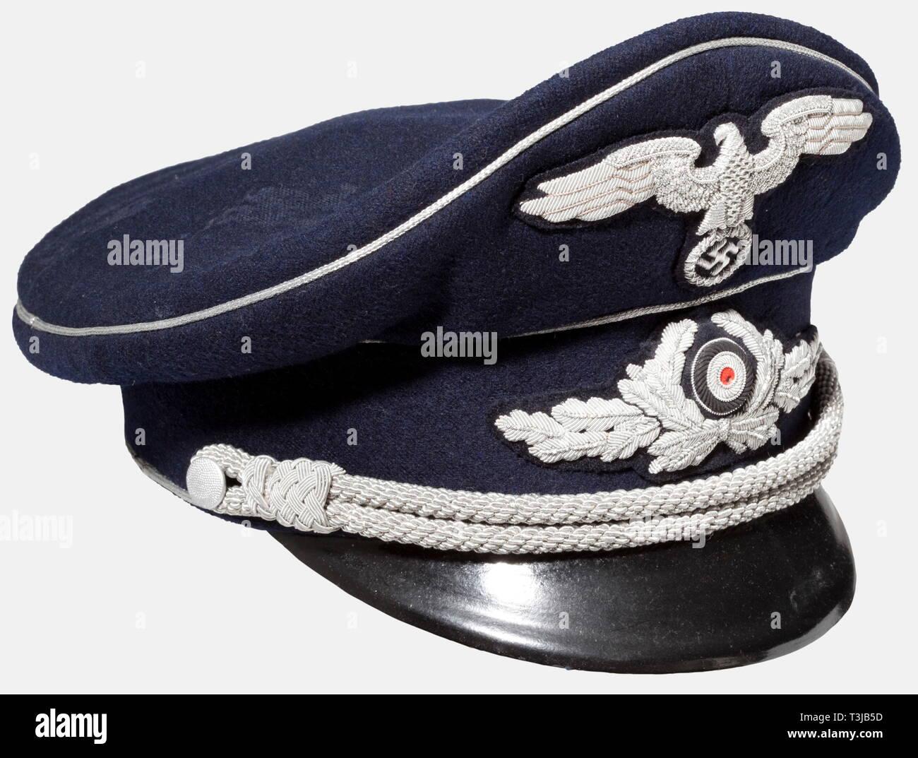 A visor cap, for diplomats and government officials Midnight-blue woolen material with silver piping, national eagle and oak leaf wreath of high quality silver embroidery. Silver cap cording. Gold-coloured silk liner, brown sweatband of ersatz material. Almost never worn, some roughness to the body, small damage to the cockade. historic, historical, 1930s, 1930s, 20th century, diplomacy, organisation, organization, organizations, organisations, Diplomatic service, foreign policy, Diplomatic services, object, objects, stills, clipping, cut out, cut-out, cu, No-Exclusive-Use | Editorial-Use-Only Stock Photo
