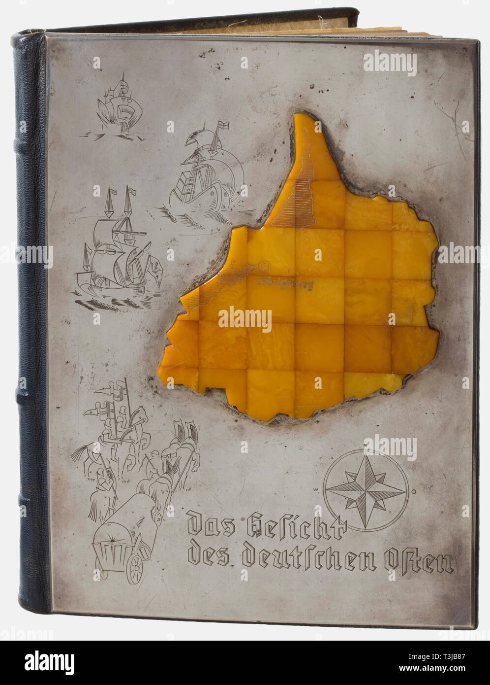 A deluxe edition 'Das malerische Ostpreußen', from a distinguished German amber collection Illustrated book on East Prussia with 122 photographs and a preface by Gauleiter Erich Koch. 215 pages (partially damaged/spotted/one missing?), publ. by Gräfe und Unzer, Königsberg, no date. Blue leather cover, the front applied with a silver plaque bearing an amber panelled image of East Prussia with the engraved portrayal of Königsberg, the silver plaque also engraved, offshore the coast of East Prussia three cogs and a horse cart coming from West Prussia protected by knights. The , Editorial-Use-Only Stock Photo