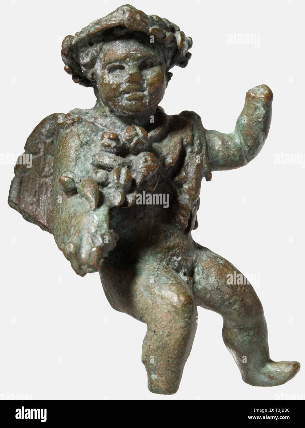 A Roman putto seated in riding position, 1st - 2nd century A.D. Cast bronze complemented by cold-working. The boy was probably originally riding a dolphin, the left arm raised, wearing around his neck a fruit garland, the head crowned with a leaf wreath, the finely modelled head with pierced eyes turned slightly to the left. Fine, dark green patina, the right foot and left hand missing, the wings slightly damaged. Height 7.8 cm. A well-crafted small bronze figure of Roman origin. Provenance: German private collection, 1970s. historic, historical,, Additional-Rights-Clearance-Info-Not-Available Stock Photo