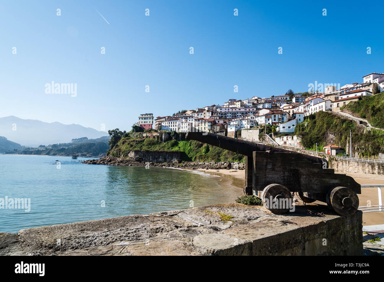 Scenic view of the beautiful fishing village of Lastres in Asturias. Old gun on foreground Stock Photo