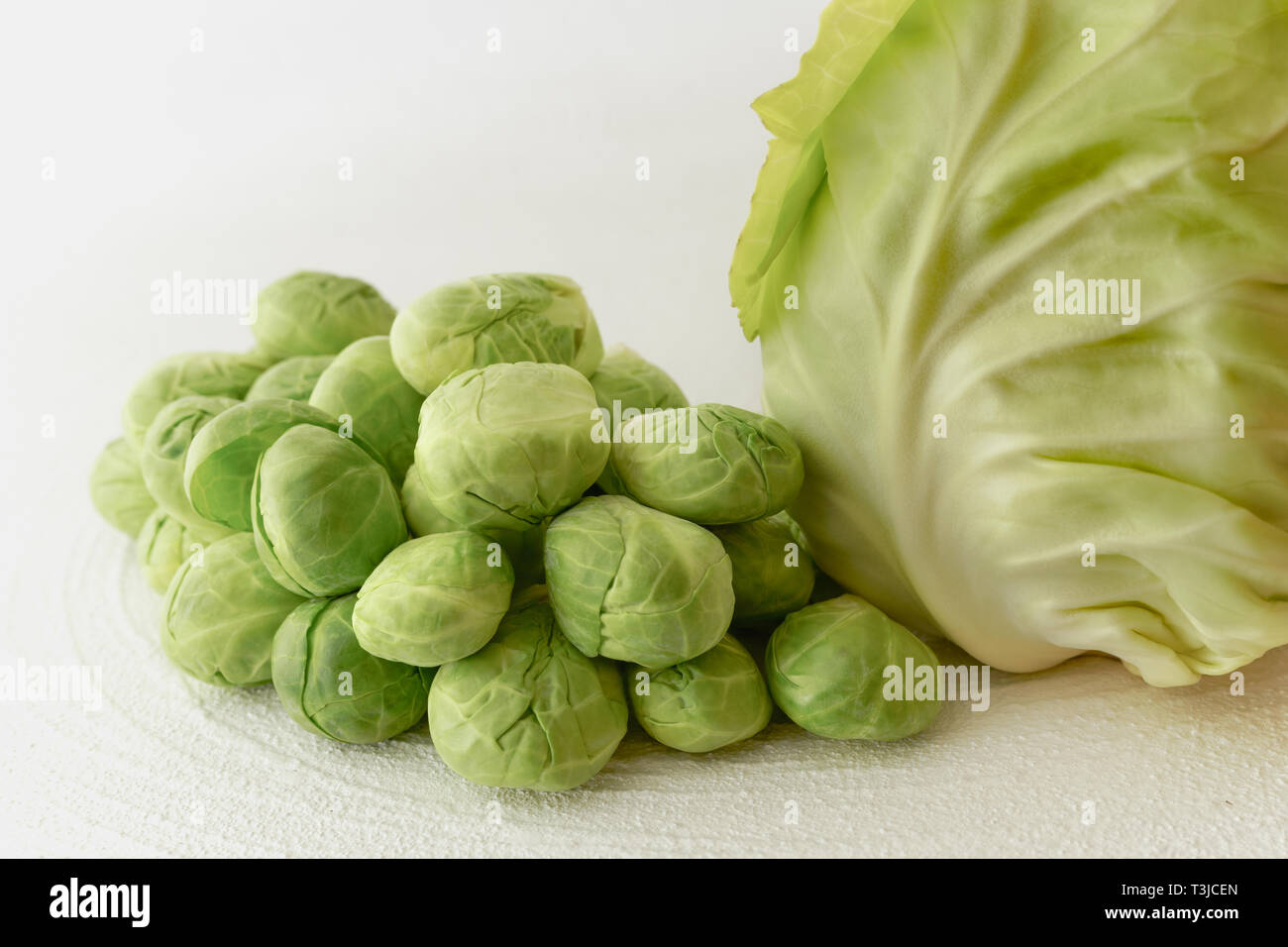 Close up of Brussels Sprouts and Green Cabbage on White Background Stock Photo