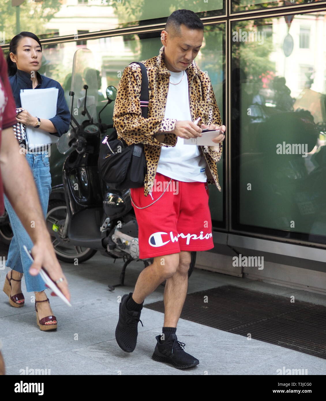 MILAN - JANUARY 15: Man with orange shirt and red Louis Vuitton Supreme bag  looking at phone before Represent fashion show, Milan Fashion Week street  Stock Photo - Alamy