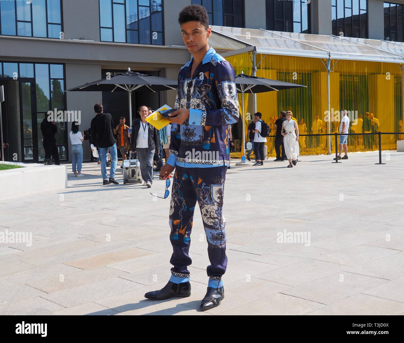 MILAN, ITALY -JUNE 16, 2018:Young man model  posing for photographers after Neil Barrett fashion show, during Milan Fashion Week Stock Photo