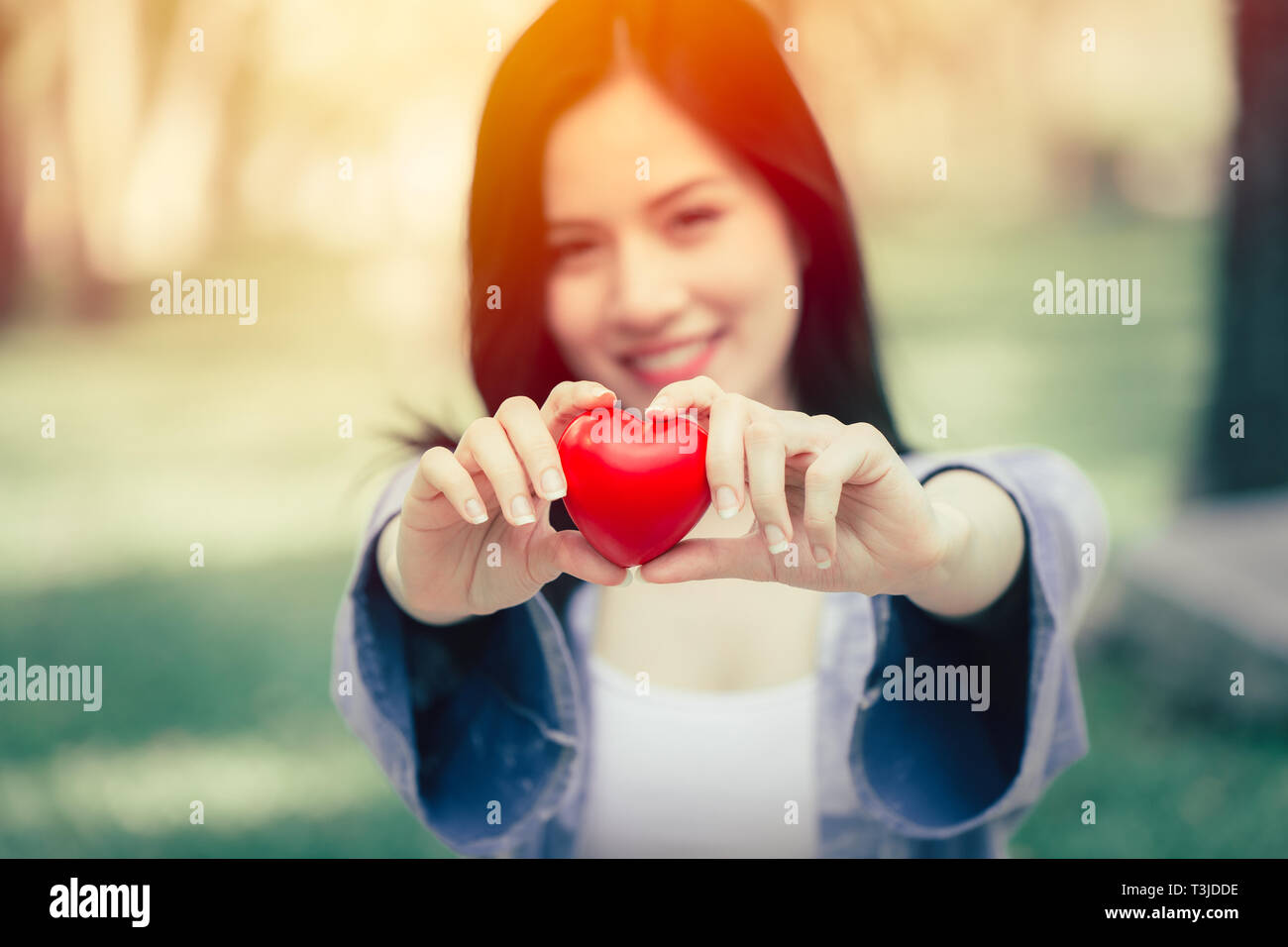 cute teen girl giving heart love concept vintage color tone Stock Photo