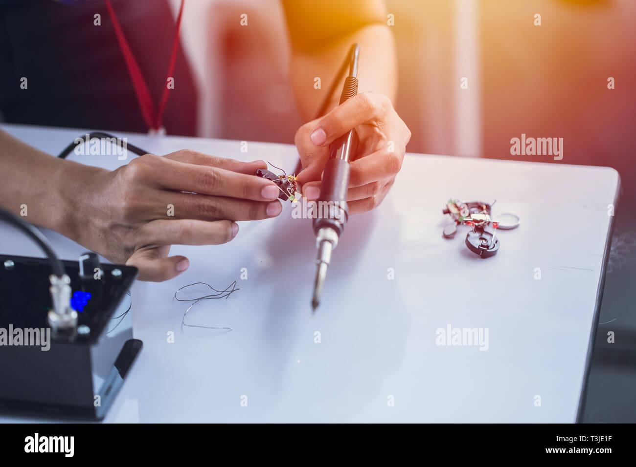 electornic engineer using soldering iron to making small circuit robot hardware. Stock Photo