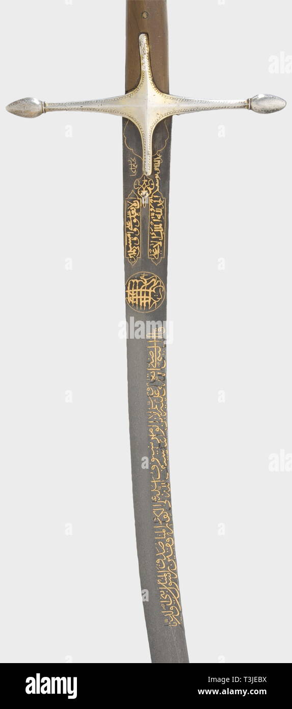 An Ottoman silver-mounted kilij, 17th/19th centuries Curved single-edged blade (1st half of the 17th century) of beautifully figured wootz-Damascus with a broadened, double-edged point. The obverse side bears a long inscription from the Koran, inlaid in gold, surrounded by the 'Basmala' (first verse of the Koran), and followed by two inscription cartouches and the signature, 'Haji Sungar's work'. Silver quillons and grip frame with riveted rhinoceros horn grip scales. Wooden scabbard, wound with cord, the middle covered with shagreen leather and , Additional-Rights-Clearance-Info-Not-Available Stock Photo