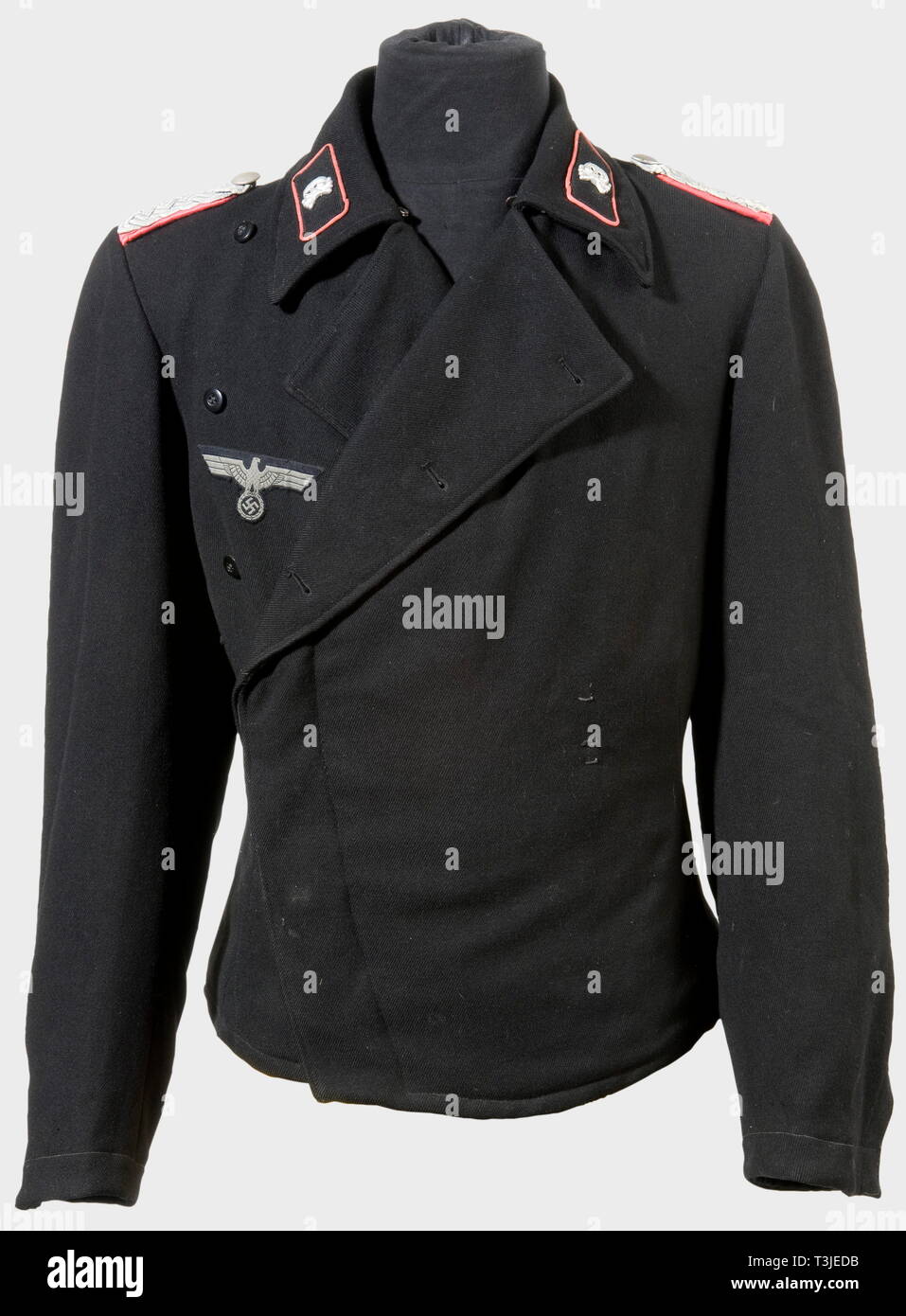 A jacket of the black special uniform, for a major in the panzer units Black gabardine fabric, brown cotton lining with stock and size stamps, black synthetic resin buttons, BeVo eagle, collar patches with pink piping and aluminium death's heads, fixed shoulder straps (replacement field-grey buttons), order loops for the ribbon bar. Traces where the fabric version of the German Cross in Gold had been sewn on. historic, historical, 1930s, 1930s, 20th century, armoured corps, armored corps, tank force, tank forces, branch of service, branches of service, armed service, armed , Editorial-Use-Only Stock Photo
