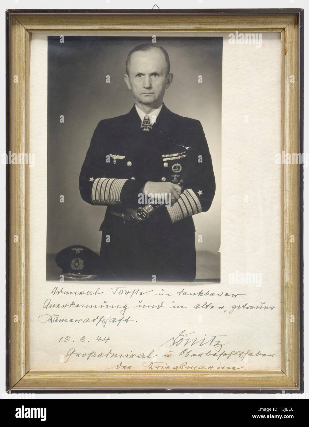 Grand Admiral Karl Dönitz, a 1944 official presentation photograph to Admiral Förster Large format studio photo in uniform with the Knight's Cross with Oak Leaves, and the Grand Admiral's baton in his right hand. On passepartout with hand-written dedication in ink (translated), 'Admiral Förster in thankful recognition and in old, loyal friendship, 18 August 1944 Dönitz, Grand Admiral and Commander-in-Chief of the Navy'. 20 x 28 cm, in a simple wooden frame, 34 x 44 cm. people, 1930s, 20th century, navy, naval forces, military, militaria, branch of service, branches of servi, Editorial-Use-Only Stock Photo