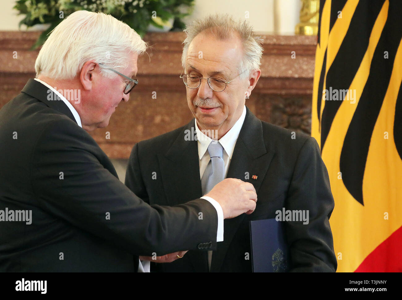10 April 2019, Berlin: Federal President Frank-Walter Steinmeier (l) awards the outgoing head of the Berlinale, Dieter Kosslick, the Order of Merit of the Federal Republic of Germany in Bellevue Castle. Photo: Wolfgang Kumm/dpa Stock Photo