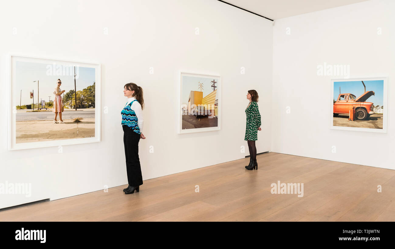 London, UK.  10 April 2019.  Staff members view works by American photographer William Eggleston at his new exhibition '2¼' at the David Zwirner gallery in Mayfair.  The show comprises a series of square-format colour photographs taken around 1977 throughout California and the American South and will run April 12 to June 1, 2019.  Credit: Stephen Chung / Alamy Live News Stock Photo