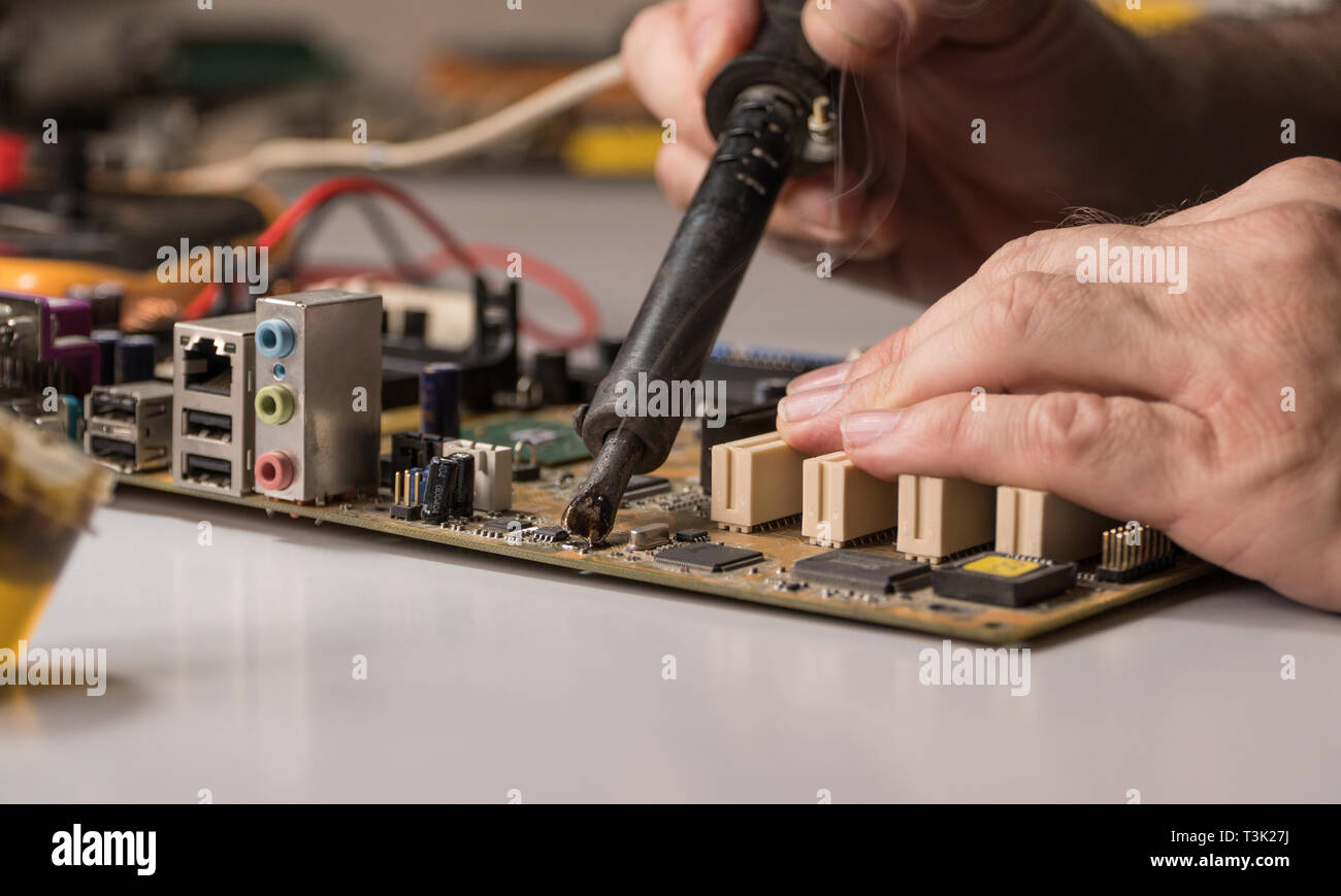 technician electronic soldering and repairing computer chip Stock Photo Alamy