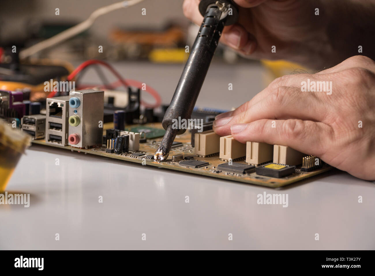 technician electronic soldering and repairing computer chip Stock Photo