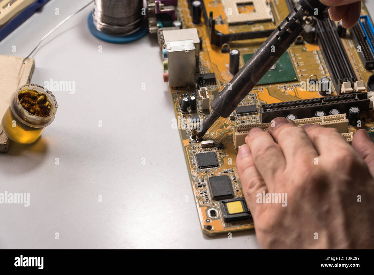 technician electronic soldering and repairing computer chip Stock Photo Alamy
