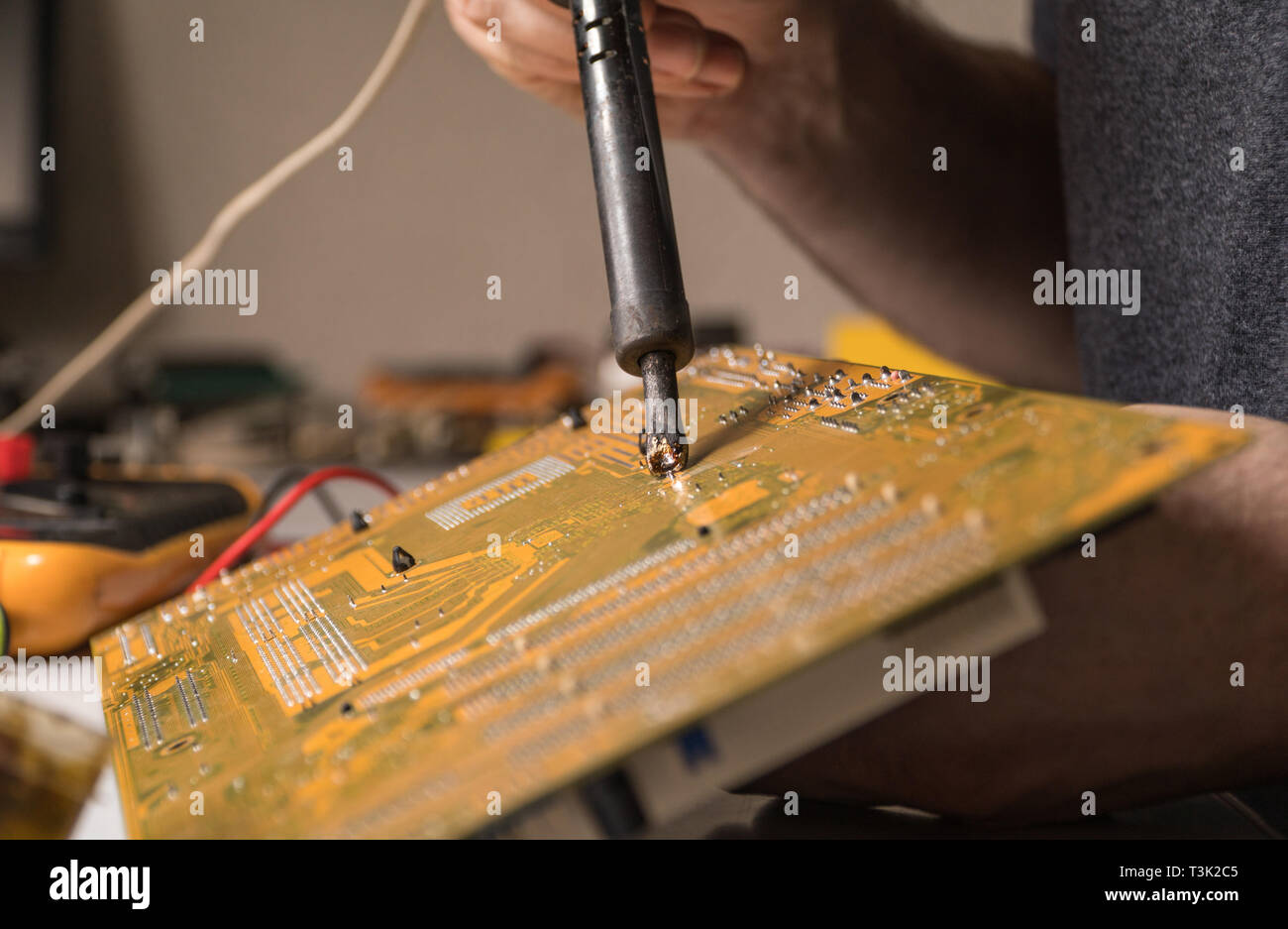 technician electronic soldering and repairing computer chip Stock Photo