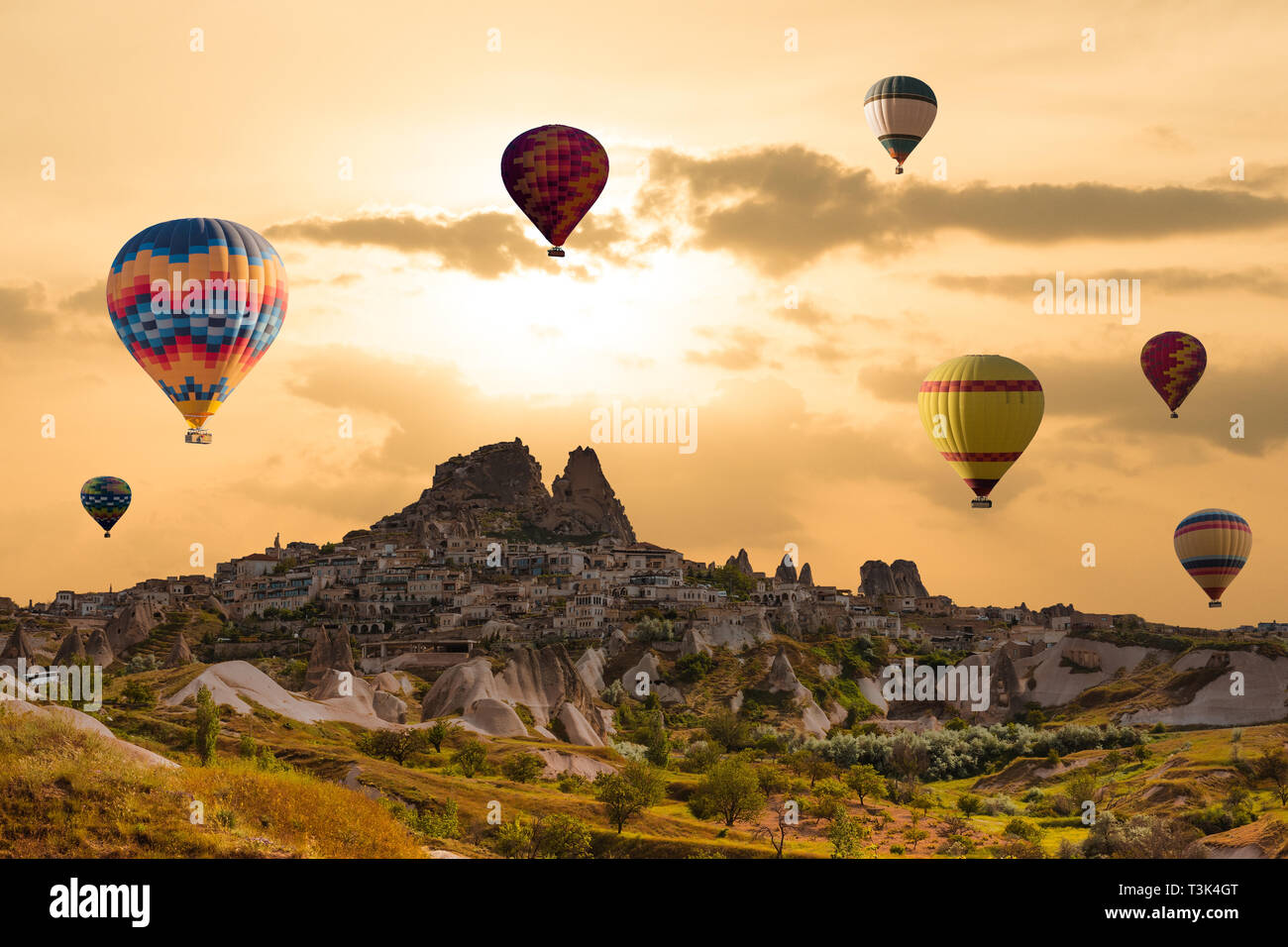 Colorful hot air balloons flying over the valley at Cappadocia, Uchisar, Turkey. Volcanic mountains in Goreme national park Stock Photo