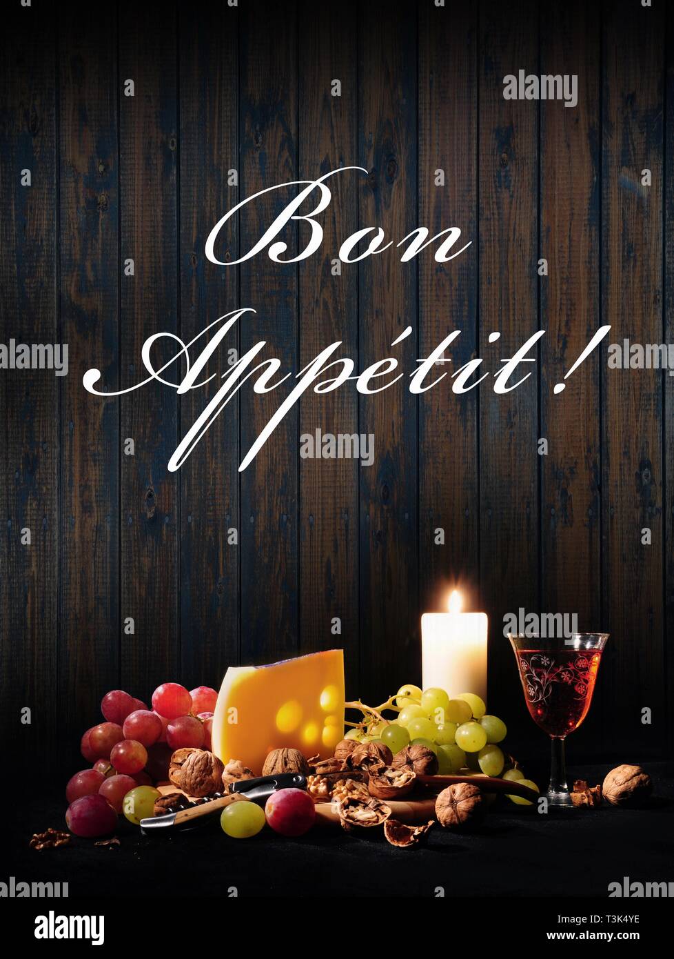 Still life with wine, cheese, grapes, candle, Bon Appetit! Stock Photo