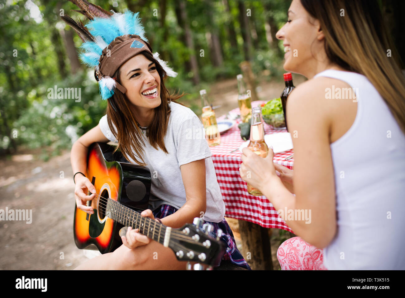 Group of friends having a picnic in a park outdoor. Happy young people enjoying bbq Stock Photo