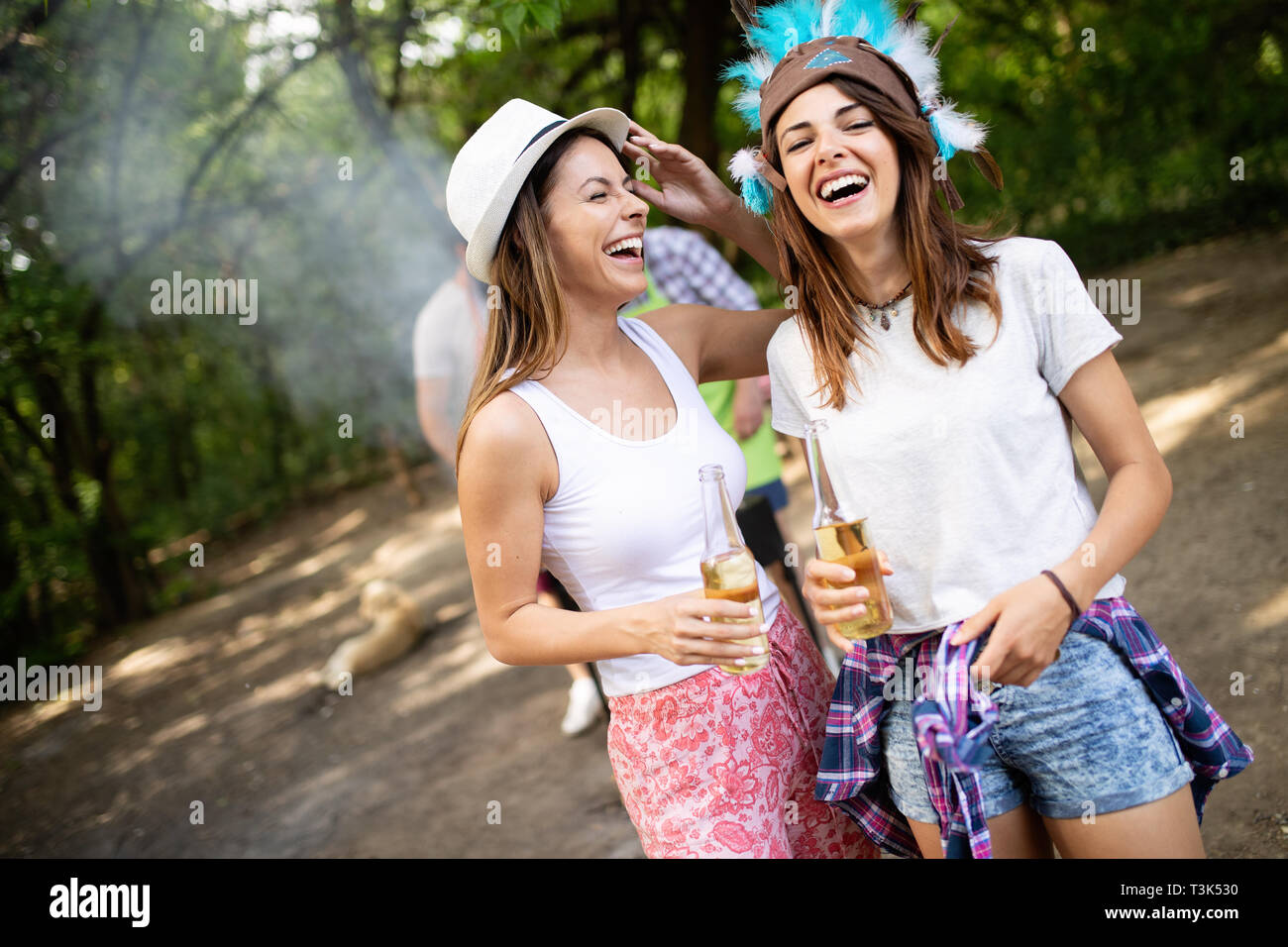 Group of friends having a picnic in a park outdoor. Happy young people enjoying bbq Stock Photo