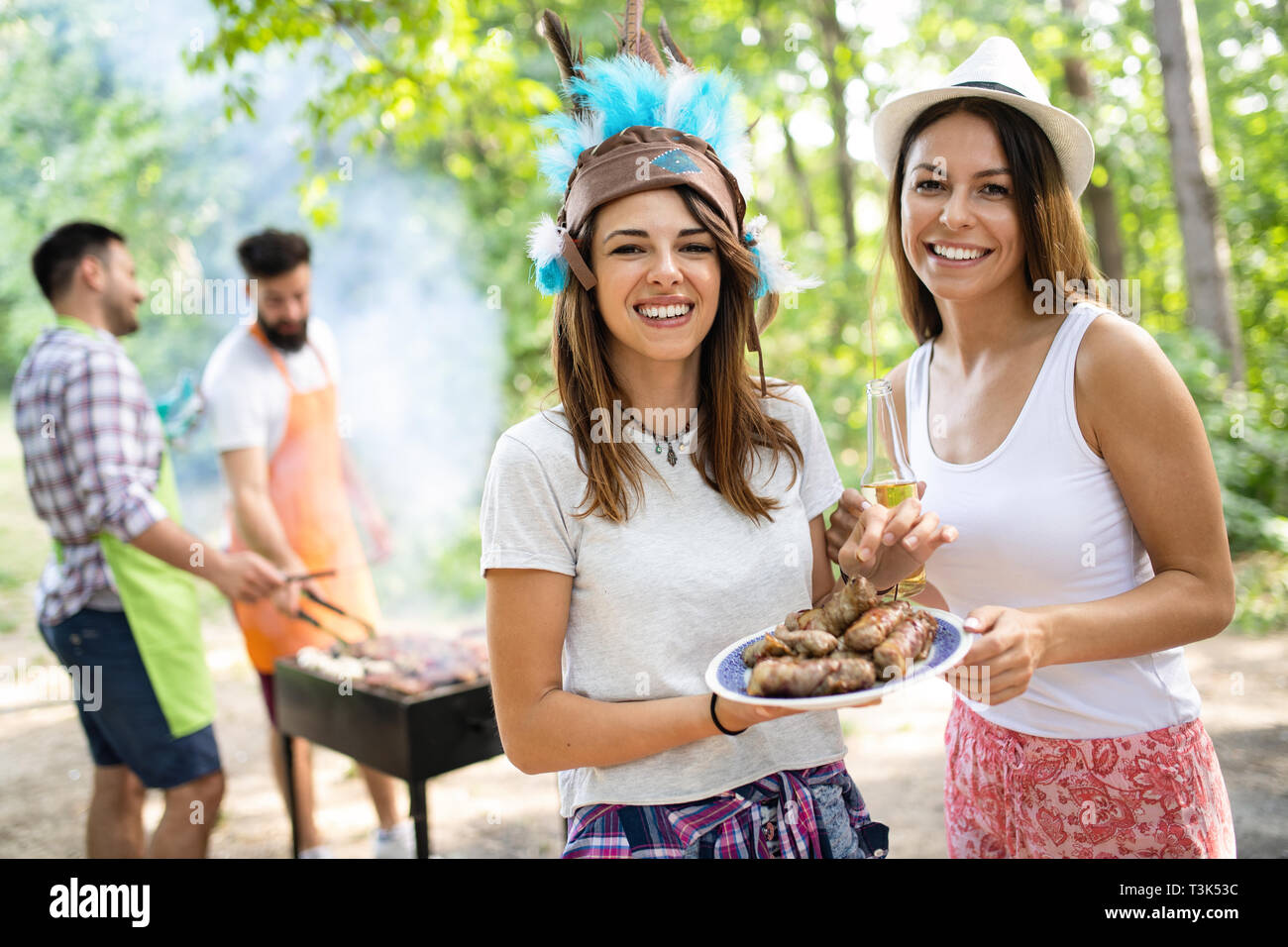 Group of friends having a barbecue and grill party in nature Stock ...
