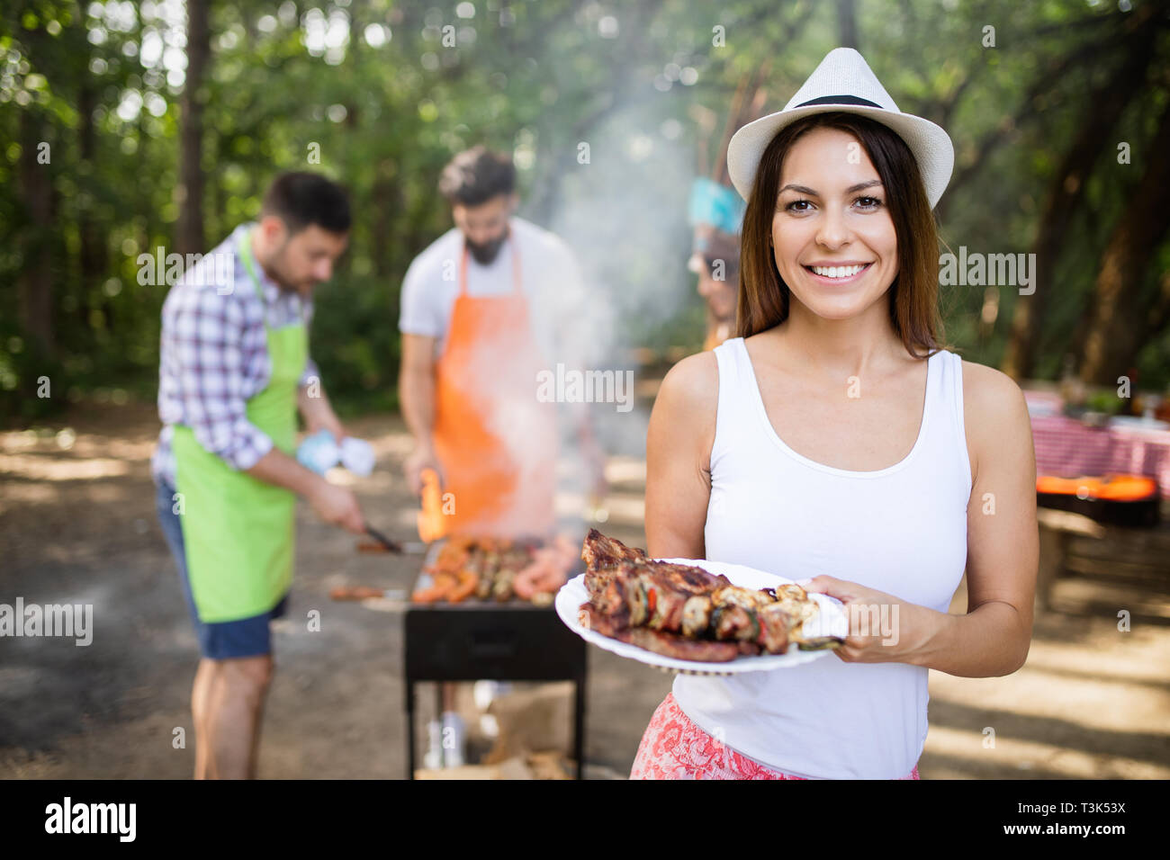 Group of friends having a barbecue party in nature Stock Photo - Alamy