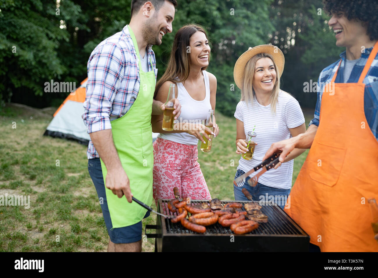 Group of friends having a barbecue and grill party in nature Stock Photo -  Alamy