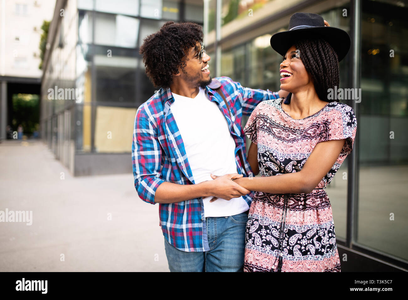 Happy young black couple hugging and laughing outdoors Stock Photo - Alamy