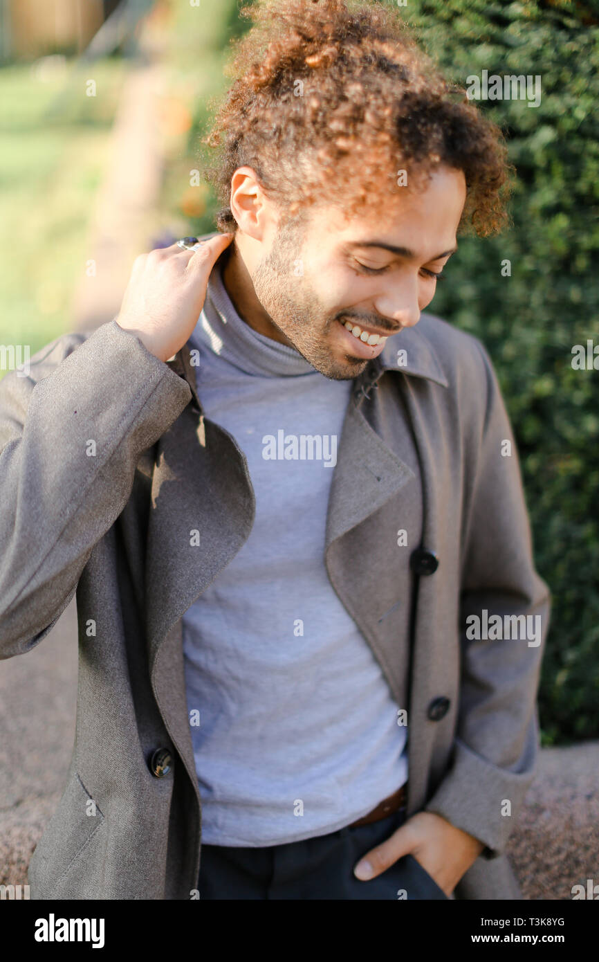 Afro American Young Boy With Curly Hair Smiling And Standing Outside Concept Of Black Male Person Stock Photo Alamy