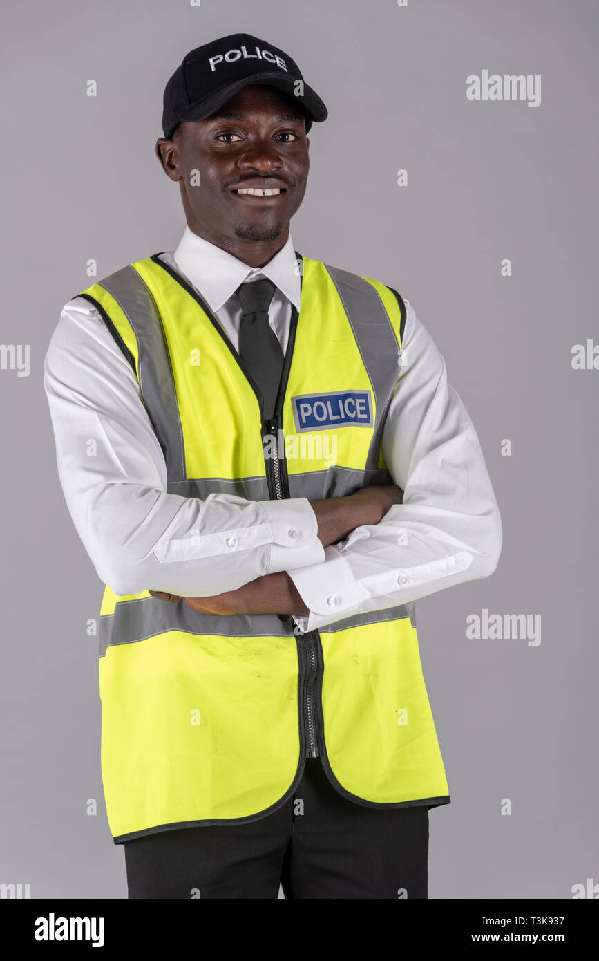 Portrait of a police officer in uniform with arms folded Stock Photo
