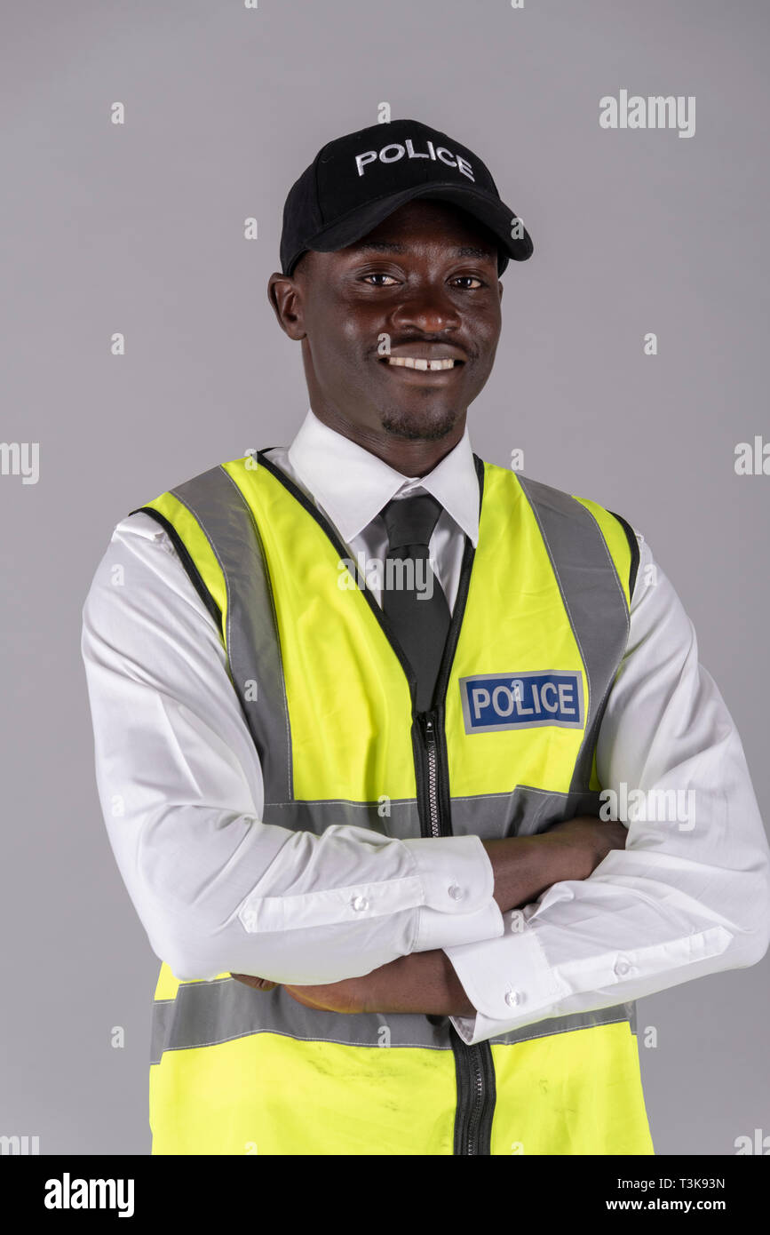 Portrait of a police officer in uniform with arms folded Stock Photo