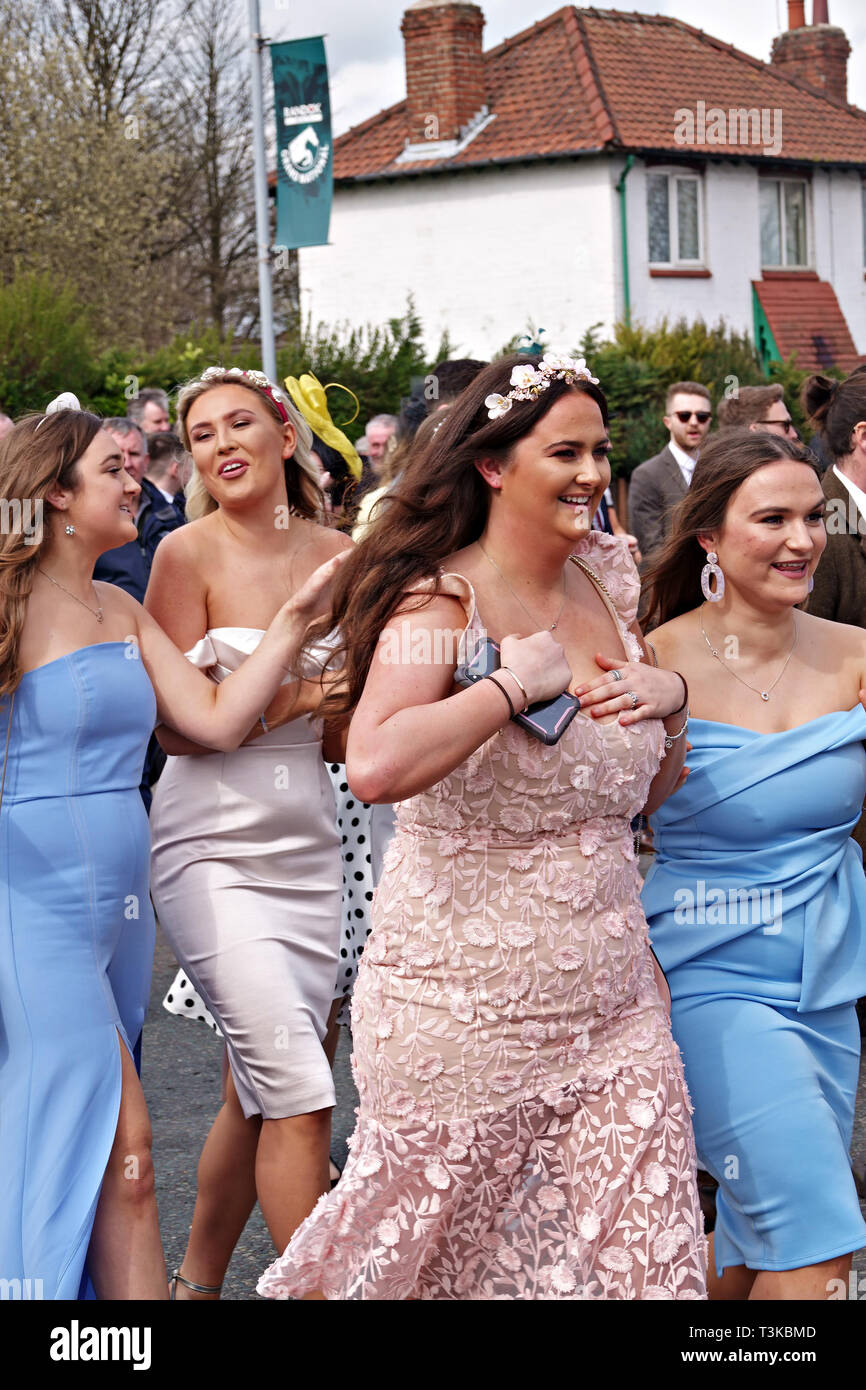 Women dress up for a day out on Ladies Day at the 2019 Aintree Grand National Meeting Stock Photo