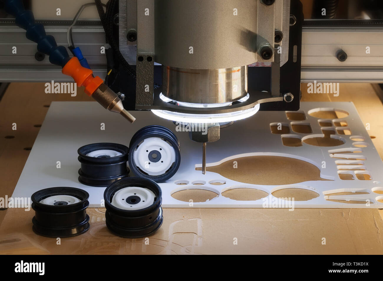 Desktop CNC machine used to make scale model rims and wheels from ABS plastic material. Stock Photo