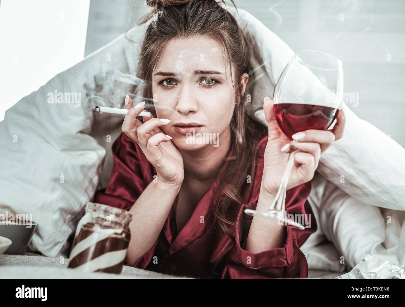 Stressed woman performing bad habits while being depressed Stock Photo